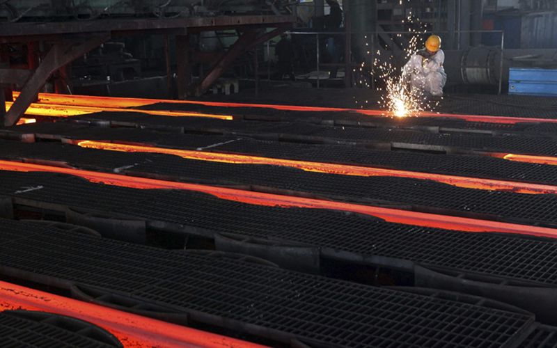 A worker cuts crude steel on a production line at a steel factory in Ganyu, Jiangsu province July 11, 2013. u00e2u20acu201d Reuters pic
