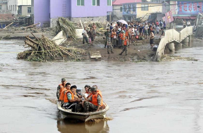 Soldiers use a speedboat to transport residents across a river after a bridge collapsed during sweeping floods in Fushun, Liaoning province, August 17, 2013. u00e2u20acu201d Reuters pic