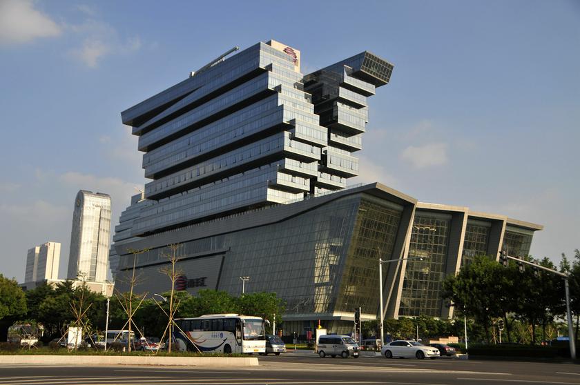 Vehicles travel past a commercial building in Guangzhou, Guangdong province September 27, 2013. u00e2u20acu201d Reuters pic