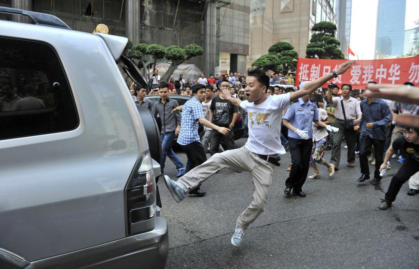 A demonstrator kicks a Japanese-brand car during a protest in Chongqing, in this September 15, 2012 file photo. u00e2u20acu201c Reuters pic