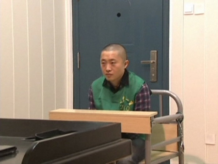 Journalist Chen Yongzhou sits in a detention room at the Changsha Public Security Bureau detention centre in Changsha City, Hunan Province, in this still image taken from China Central Television (CCTV) video shot on October 25, 2013. u00e2u20acu201d Reuters pic