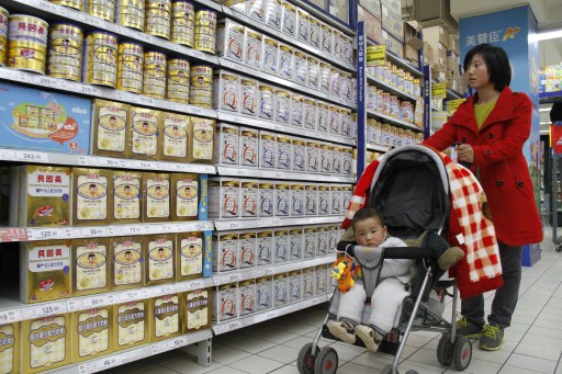 A woman looks at baby milk powder in a supermarket in Nanjing, east China's Jiangsu province on March 29, 2013. u00e2u20acu201d AFP pic