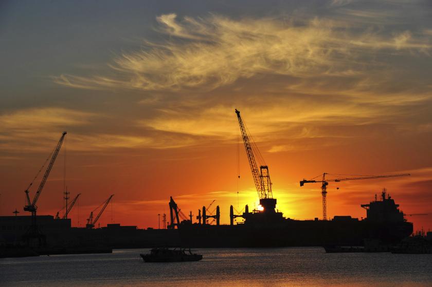 A shipyard is silhouetted against the rising sun in Dalian, Liaoning province, January 28, 2014. u00e2u20acu201d Reuters pic