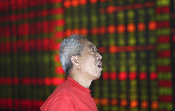An investor looks at an electronic board showing stock information at a brokerage house in Shenyang, Liaoning province August 16, 2013. u00e2u20acu201d Reuters pic