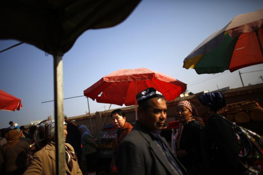 Ethnic Uighur people walk along a busy market in Turpan, Xinjiang province October 31, 2013. u00e2u20acu201d Reuters pic