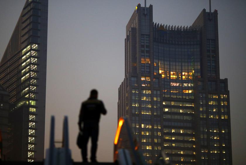 A man stands on an escalator in the financial district of Pudong in Shanghai in this November 20, 2013. u00e2u20acu201d Reuters pic