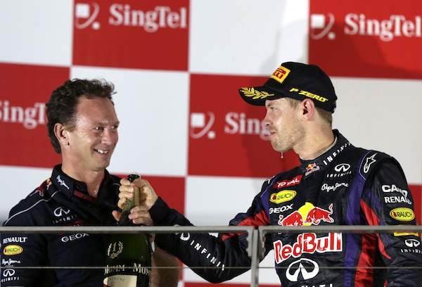 Red Bull team principal Christian Horner celebrates on the podium with Red Bull Formula One driver Sebastian Vettel of Germany after Vettel won the Singapore F1 Grand Prix September 22, 2013. u00e2u20acu201d Reuters pic