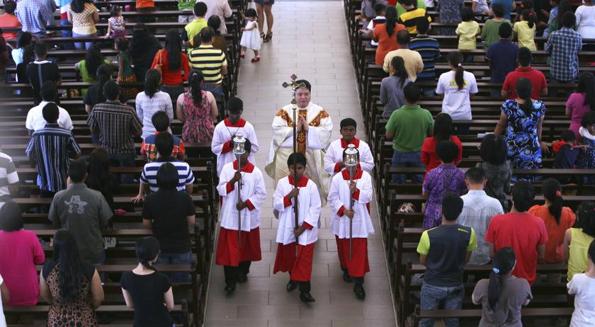 A priest and altar boys walk down the aisle after prayers were conducted during a mass service inside the church of Our Lady of Lourdes at Klang, outside Kuala Lumpur January 12, 2014. u00e2u20acu201d Reuters pic