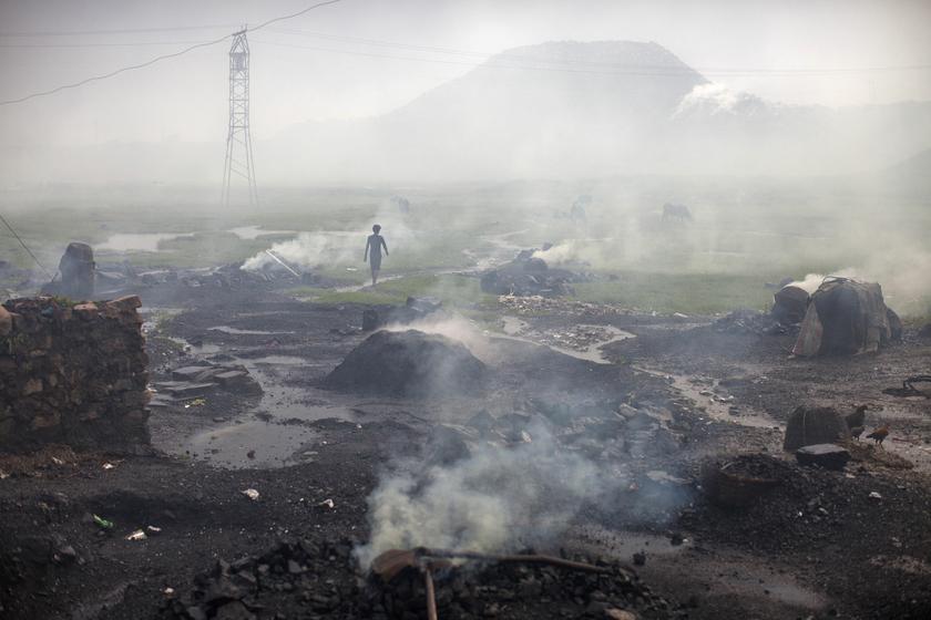 A man walks past heaps of burning coal to make it for domestic use such as for cooking purposes at Dhanbad district in the eastern Indian state of Jharkhand September 20, 2012. u00e2u20acu201d Reuters pic
