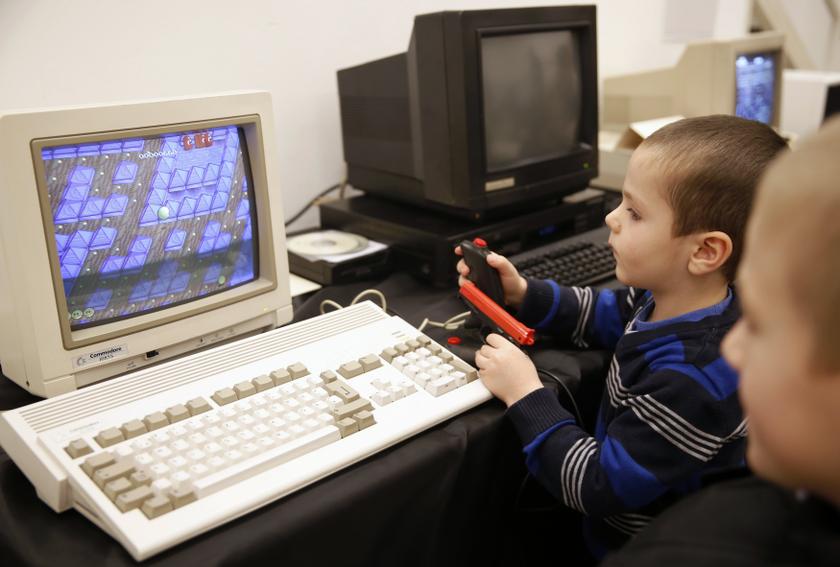 Boys play a game on the Commodore personal computer during the u00e2u20acu02dcHistory of Computersu00e2u20acu2122 exhibition in Sarajevo November 30, 2013. u00e2u20acu201d Reuters pic
