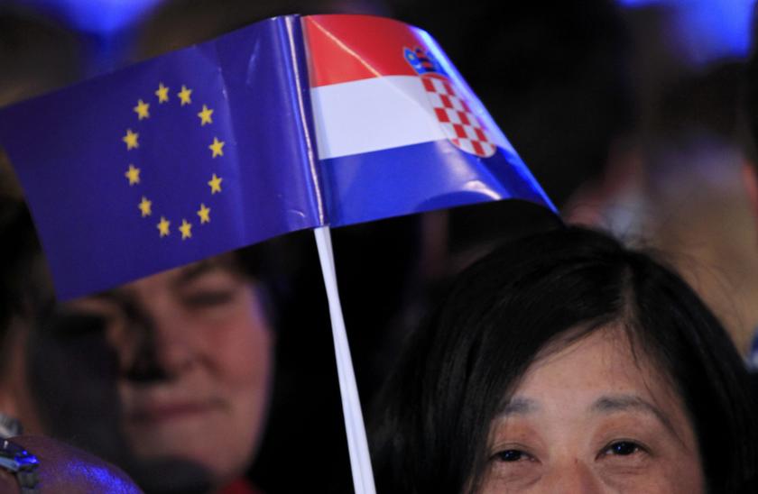 A woman holds the EU and Croatian flags during the celebration of the accession of Croatia to the European Union in Zagreb June 30, 2013. u00e2u20acu201d Reuters pic