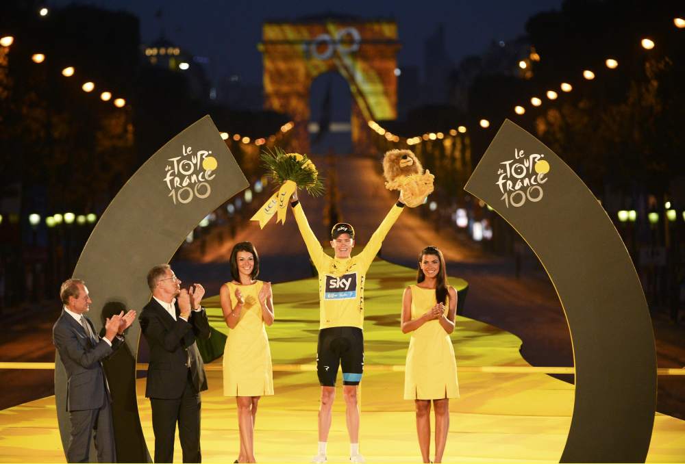 Christopher Froome of Britain, winner of the centenary Tour de France cycling race, celebrates his overall victory on the podium after the 133.5km final stage from Versailles to Paris Champs Elysees on July 21, 2013. u00e2u20acu201d Reuters pic