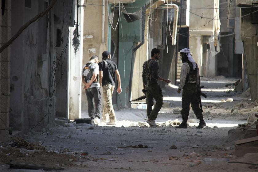 Free Syrian Army fighters hold their weapons as they walk along a damaged street near the frontline where clashes with forces loyal to Syria's President Bashar al-Assad are taking place in Beit Hajira near Damascus, July 7, 2013. u00e2u20acu201c Reuters pic