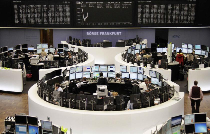 Traders are pictured at their desks in front of the DAX board at the Frankfurt stock exchange. u00e2u20acu201d Reuters pic