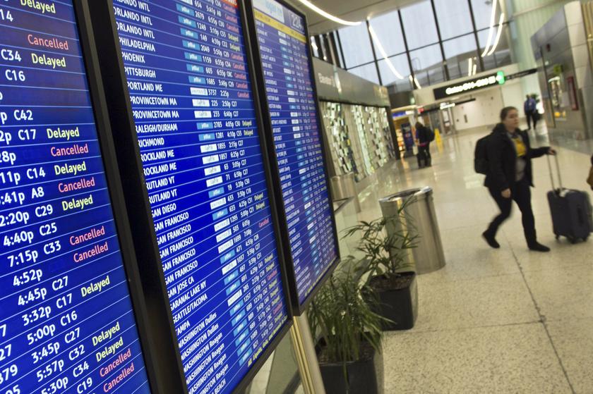 A woman walks past a flight information board displaying delays and cancellations at Logan International Airport during a winter nor'easter snow storm in Boston, Massachusetts January 2, 2014. u00e2u20acu201d Reuters pic