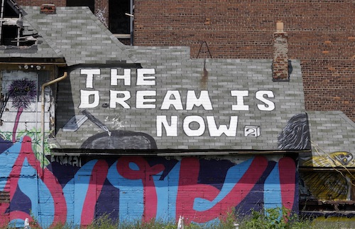 Graffiti u00e2u20acu02dcThe Dream is Nowu00e2u20acu2122 is seen painted on the roof of a vacant blighted home in a once vibrant neighbourhood, near downtown Detroit, Michigan July 19, 2013. u00e2u20acu201d Reuters pic 