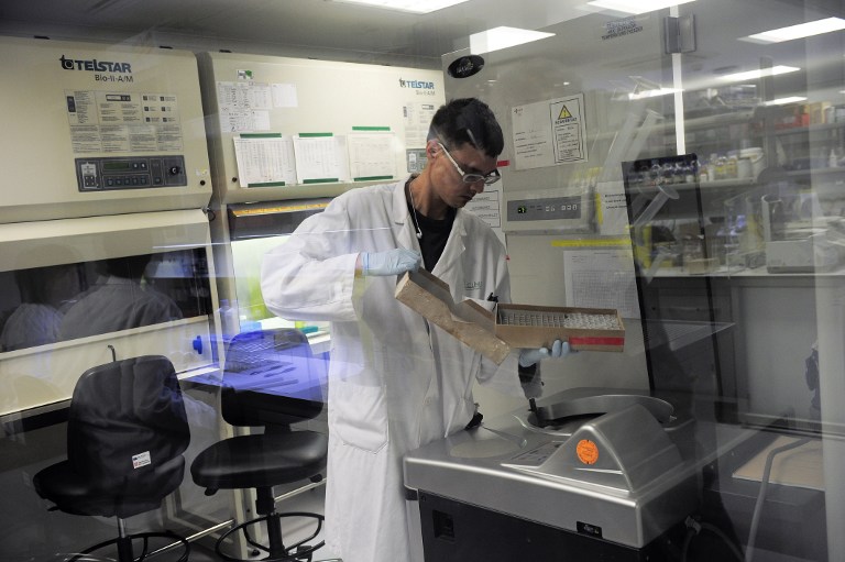A doctor works at the Institute of Biomedical Research August Pi i Sunyer (IDIBAPS) in Barcelona on December 9, 2013. Hospital Clinic presents a European project to start clinical trials of a possible therapeutic vaccine against AIDS. u00e2u20acu201d AFP