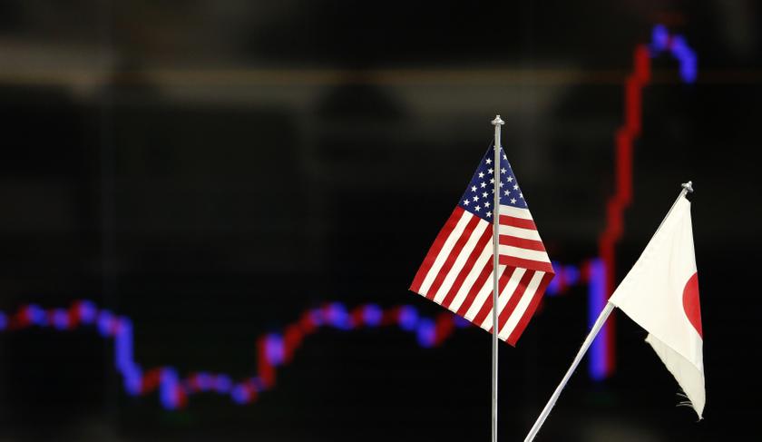 The national flags of Japan and the US are seen in front of a monitor displaying a graph of recent fluctuations of the Japanese yenu00e2u20acu2122s exchange rate against the US dollar at a foreign exchange trading company in Tokyo December 19, 2013. u00e2u20acu201d Reuters pic