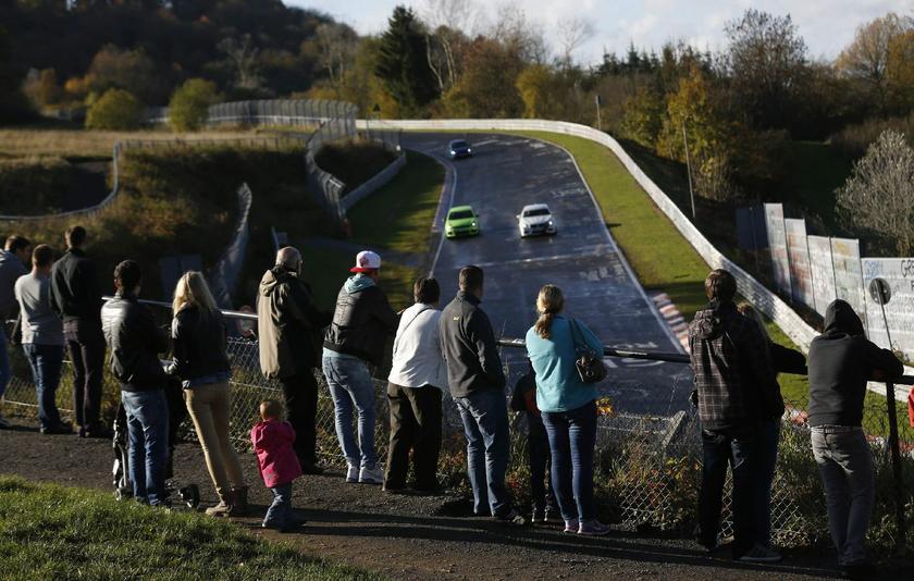 Enthusiasts watch hobbyist racers as they approach the Breidscheid section.