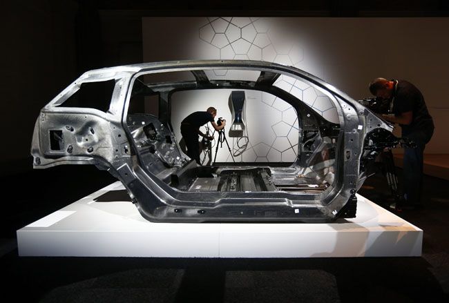 Cameramen work around the carbon fibre chassis for BMW's new i3 electric before it was unveiled in London Reuters pic