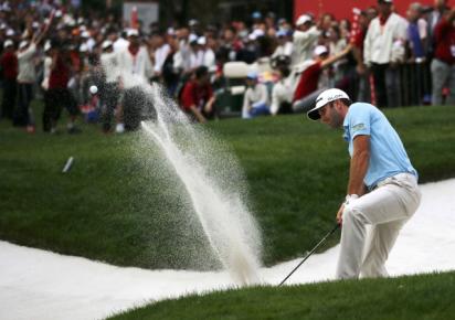 Dustin Johnson of the US hits out of a bunker on the 18th hole during the third round of the WGC-HSBC Champions golf tournament in Shanghai November 2, 2013. 