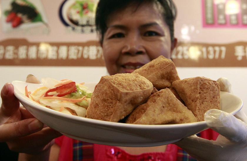 Chen Lai-hao, co-owner of Jiaziyuan Restaurant, displays a plate of fried stinky tofu in New Taipei city July 25, 2013
