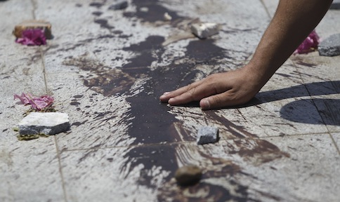 A member of the Muslim Brotherhood and supporter of deposed Egyptian President Mohamed Mursi touches the blood from pro-Mursi protesters, killed during late night clashes, at the Tomb of the Unknown Soldier, east of Cairo July 28, 2013. u00e2u20acu201d Reuters pic