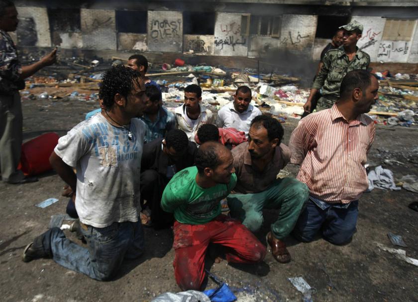 Suspects rounded up near a burnt annex building at the Rabaa Adawiya mosque in Cairo August 15, 2013.
