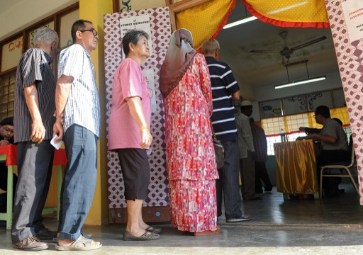 Malaysians queue outside a polling station to cast their vote in Pekan on May 5, 2013. u00e2u20acu201d AFP pic