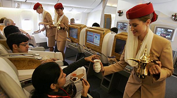 Emirates Airlines flight attendants serve passengers during a demonstration flight of the Boeing 777 long-haul aircraft in Dubai. u00e2u20acu201d AFP pic