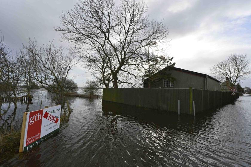 A land sale sign is seen surrounded by flood water in Long Sutton on the flooded Somerset Levels, near Langport in southwest England January 27, 2014. u00e2u20acu201d Reuters pic
