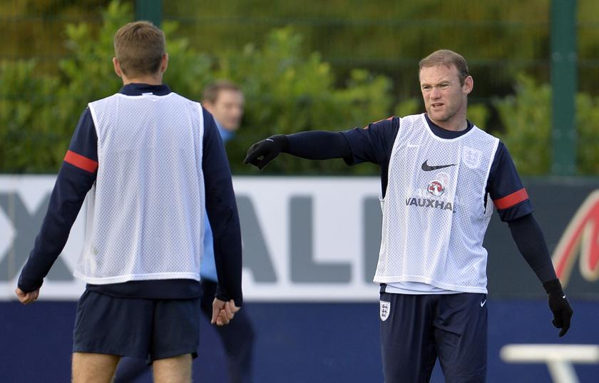 England's Wayne Rooney (R) gestures to Steven Gerrard during a training session, ahead of their 2014 World Cup qualifying football match against Montenegro, at London Colney training complex near London October 10, 2013.  u00e2u20acu201d Reuters pic