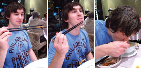 My friend Dave gracefully holding a fried shrimp with his chopsticks, pretending to eat the shrimp he has actually dropped and finally, eating dinner... properly.