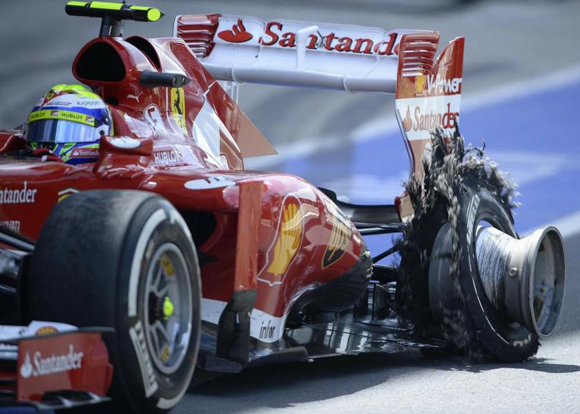 Ferrari Formula One driver Felipe Massa of Brazil enters the pit with a puncture during the British Grand Prix at the Silverstone race circuit, England, in this June 30, 2013 file photo. Pirelli supplies tyres to all 11 teams in F1 motor racing. u00e2u20acu201d Reute