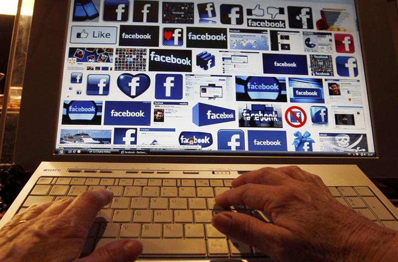 A women works with her computer which displays Facebook logos on the screen in Bordeaux, Southwestern France, January 30, 2013. u00e2u20acu201d Reuters pic