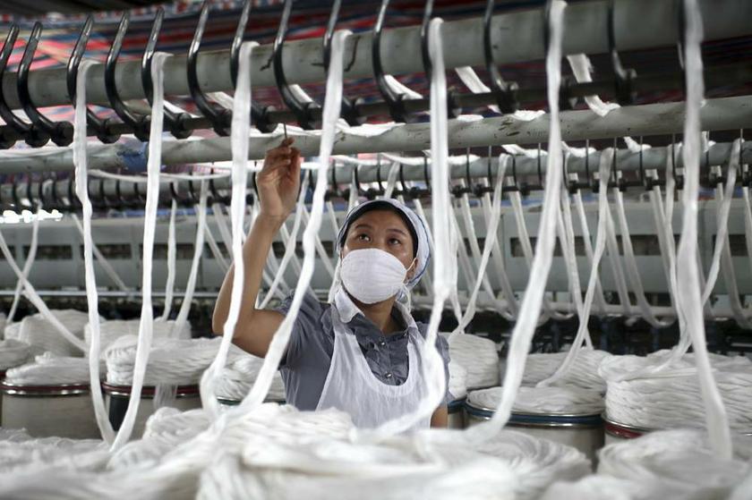 An employee works at a garment factory in Quanzhou county, Guangxi Ethnic Zhuang autonomous region in China on July 15, 2013. u00e2u20acu201d Reuters pic