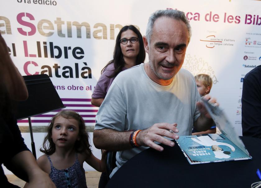 Chef Ferran Adria signs his book ,When I grow up I want to be a chef, for a fan after the book's presentation during the Catalan book week in Barcelona, Sept 10, 2013. u00e2u20acu201d Reuters pic