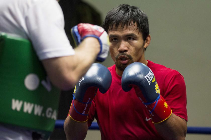 Filipino boxer Manny Pacquiao practices with his coach Freddie Roach (left) during a training session at the Venetian Macao hotel in Macau November 21, 2013. u00e2u20acu201d Reuters pic