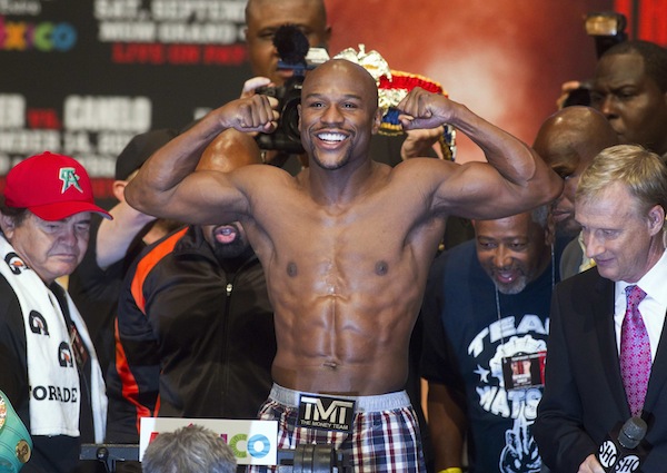 Floyd Mayweather Jr. of the US flexes on the scale during an official weigh-in at the MGM Grand Garden Arena in Las Vegas, Nevada, September 13, 2013. u00e2u20acu201d Reuters pic