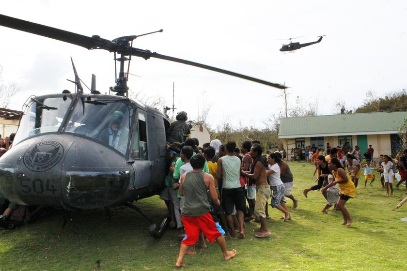 Residents rush to a military helicopter to get food packs during a relief distribution after super typhoon Haiyan hit Iloilo province, central Philippines November 11, 2013. u00e2u20acu201d Reuters pic
