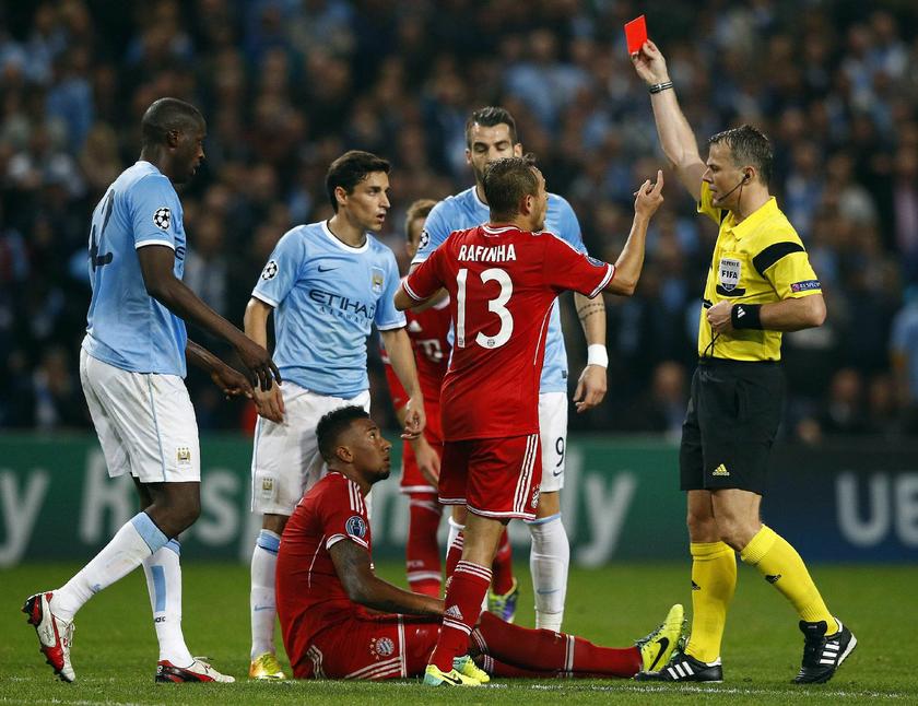 Referee Bjorn Kuipers (right) sends off Bayern Munich's Jerome Boateng (on ground) during their Champions League soccer match against Manchester City at the Etihad Stadium in Manchester, northern England, October 2, 2013. Reuters pic
