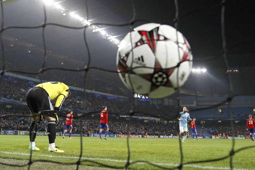CSKA Moscow Igor Akinfeev (R) slumps after Manchester City's Alvaro Negredo scores, Champions League match, Etihad Stadium in Manchester, November 5, 2013