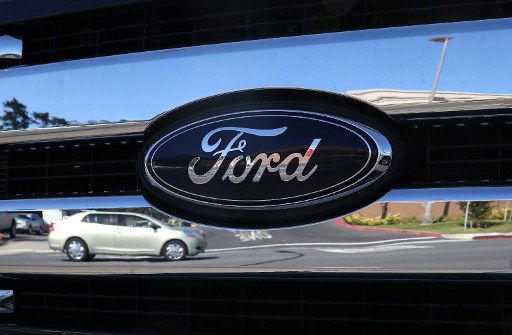 The Ford logo is displayed on the grill of a brand new truck on the sales lot at Serramonte Ford on May 1, 2013 in Colma, California. u00e2u20acu201d AFP pic