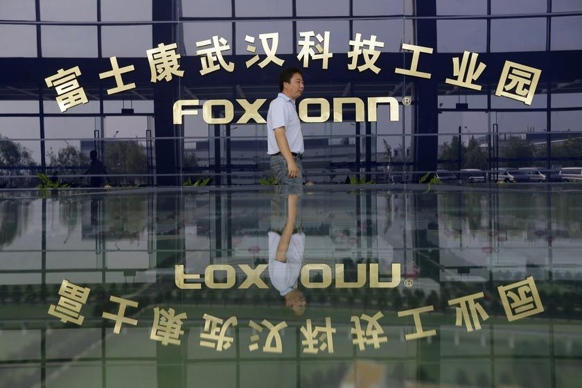 A man walks past a logo of a Foxconn factory in Wuhan, Hubei province, in this August 31, 2012 file photo. u00e2u20acu201d Reuters pic