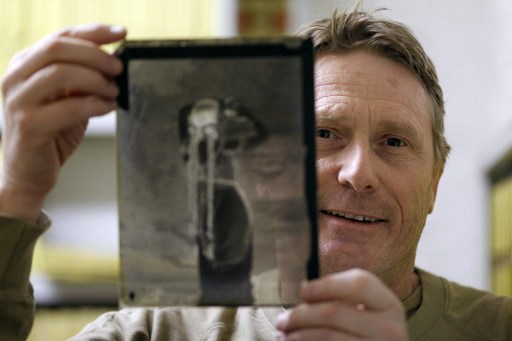 French photographer Francois Lochon poses with a file negative showing the spy Mata-Hari, on April 8, 2010 in Paris. u00e2u20acu201d AFP pic