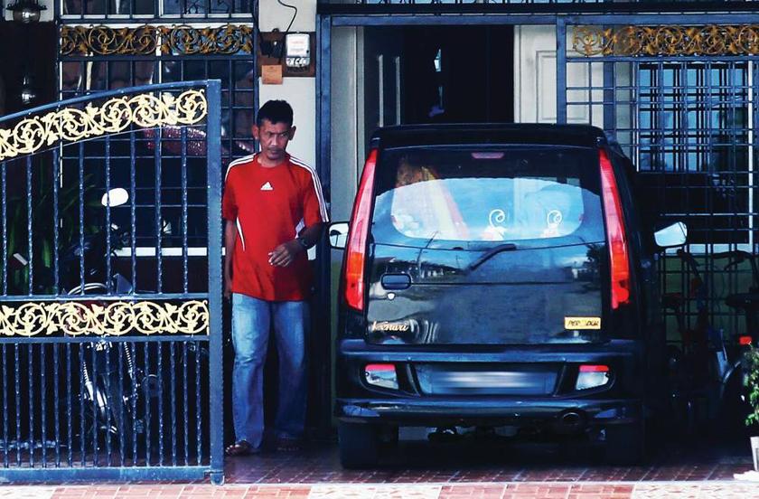 Fugitive Singaporean referee Shokri Nor going about his usual business outside his house near Sungai Petani u00e2u20acu201d Picture by The New Paper