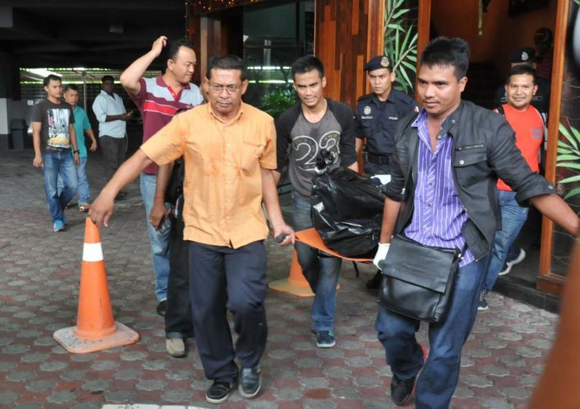 Police carrying away one of the bodies of the men killed in the shootout on August 19, 2013 in Penang. u00e2u20acu201d Picture by K.E. Ooi