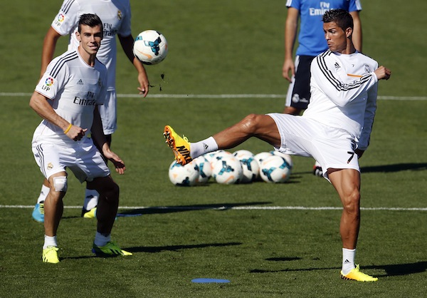 Real Madridu00e2u20acu2122s Gareth Bale (left) and Cristiano Ronaldo challenge for the ball during their training session at Valdebebas sports grounds in Madrid September 13, 2013. u00e2u20acu201d Reuters pic
