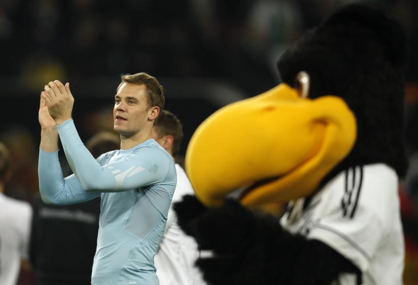 Germany's Manuel Neuer celebrates victory next to mascot 'Paule' after the 2014 World Cup qualifying match against Ireland in Cologne October 11, 2013. u00e2u20acu201d Reuters pic