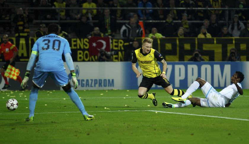 Borussia Dortmund's Marco Reus (centre) is fouled during their Champions League Group F match against Olympique Marseille at BVB stadium in Dortmund October 1, 2013. u00e2u20acu201d Reuters pic